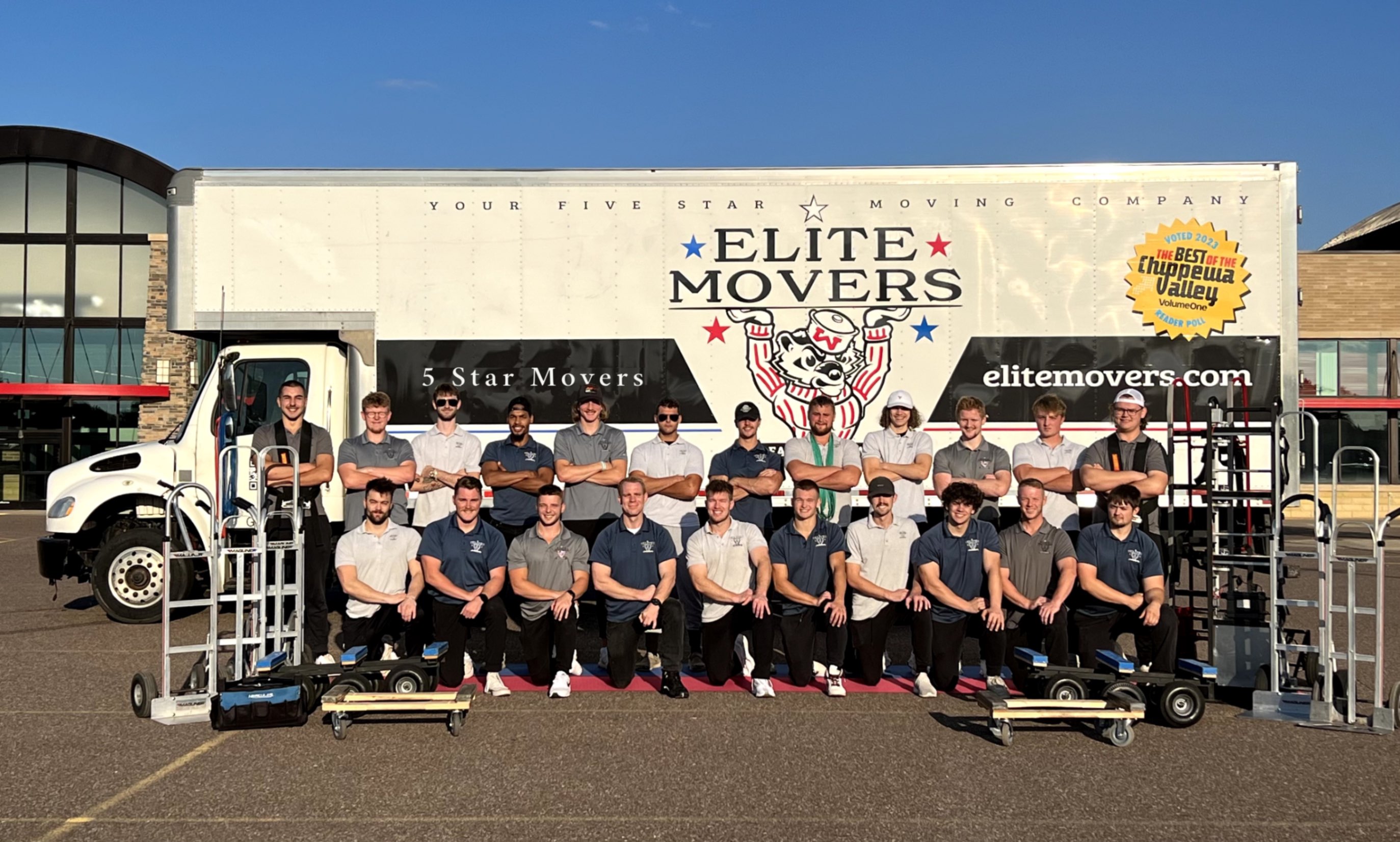 The Elite Movers team in front of the Elite Movers moving truck